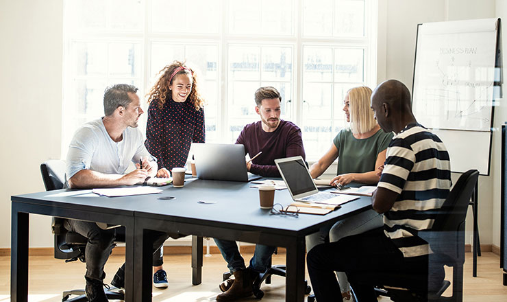 employees at a table discussing bad inventory management examples