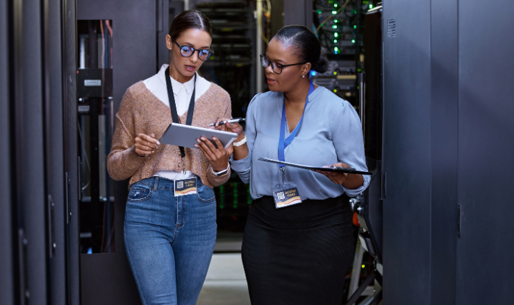 data center coworkers researching the importance of asset management on an ipad