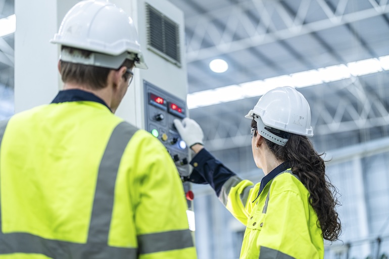 two engineers checking on an equipments life cycle