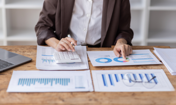 woman at desk with graphs and papers figuring out what depreciation is
