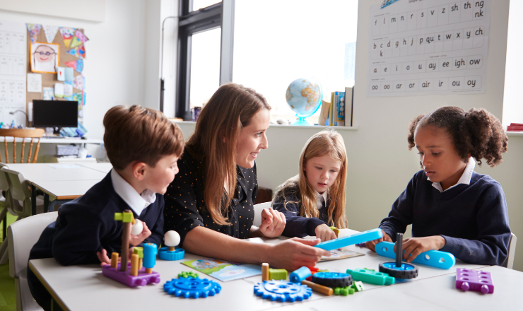 teacher and students playing with toys from the school inventory management system