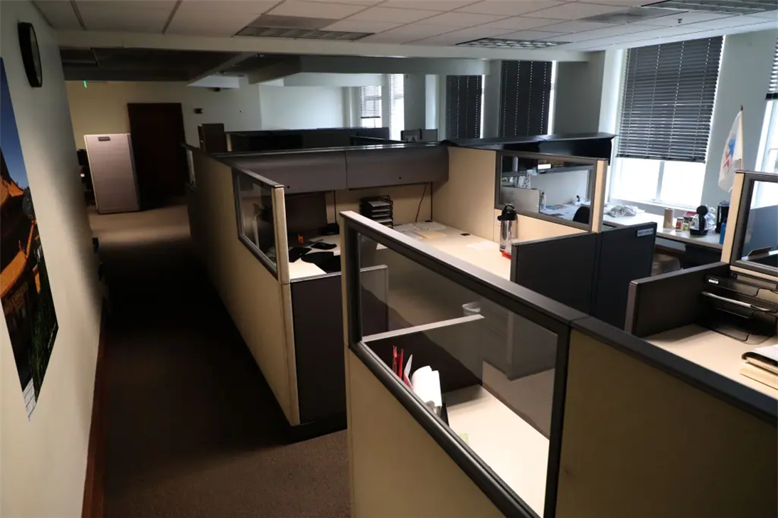 Rows of empty local government office cubicles holding departmental records