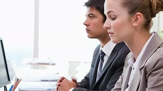 Two Avalara team members working at a desk