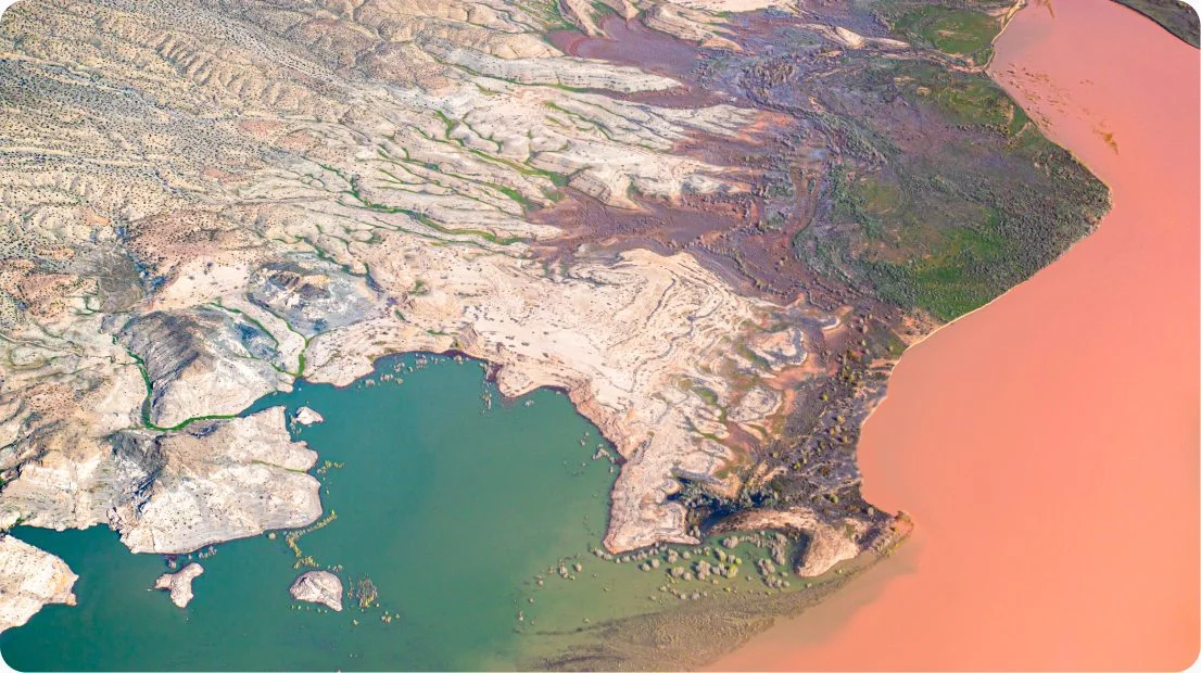 Aerial view of a river delta meeting the sea