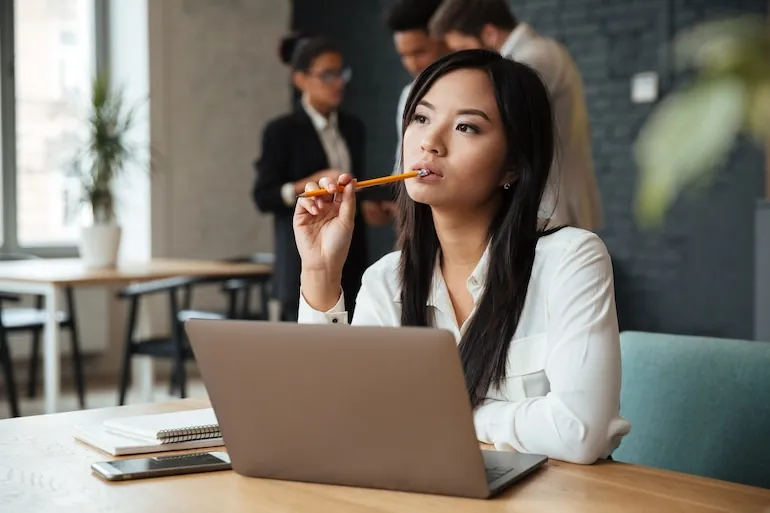 woman pondering location of ghost assets at her laptop