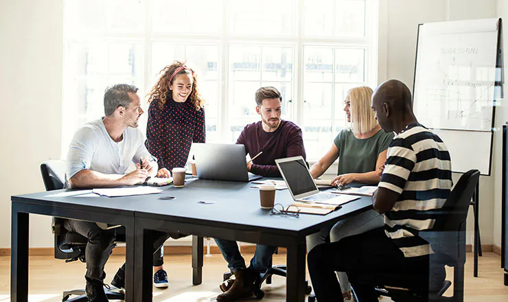 employees at a table discussing bad inventory management examples