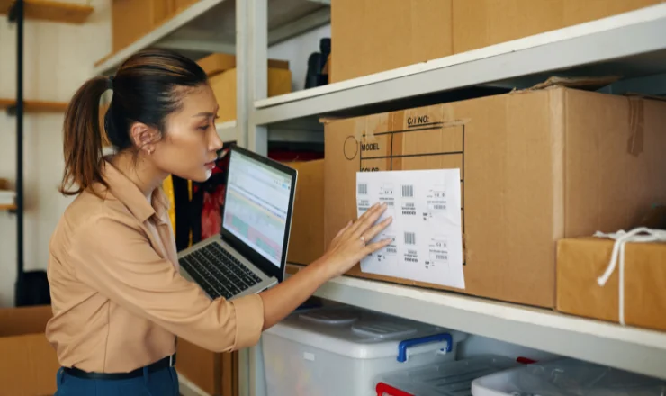 teacher looking at an asset tag for school equipment