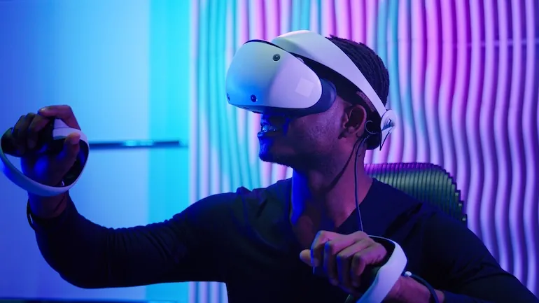 man using VR headset acquired during company